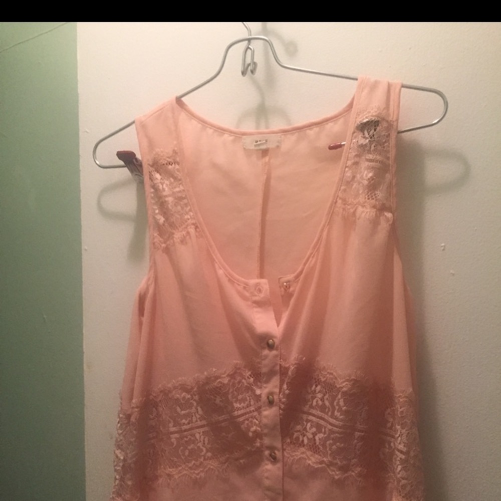 Pink top by MINE with lace and is a size medium